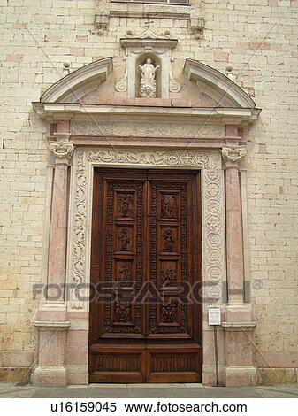 Stock Photography -  Italy, Umbria, Spello, Europe. The wooden door of the Chiesa di Santa Maria Maggiore in the medieval town of Spello.. Fotosearch