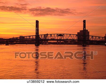 Stock Image -  Jacksonville, FL, Florida, Main Street Bridge spans the St. Johns River at sunset. Fotosearch