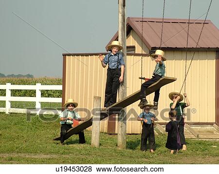 Stock Photo -  Lancaster County, PA, Pennsylvania, Amish, school, children playing on playground equipment. Fotosearch