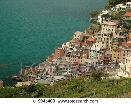 Liguria, Italy, Cinque Terre, Riomaggiore, Riviera di Levante, Ligurian Riviera, Europe, Scenic view of Riomaggiore, a Cinque Terre village, along the steep rocky coastline of the Ligurian Sea. View Large Photo Image Stock Image - Liguria, Italy, Cinque Terre, Riomaggiore, Riviera di Levante, Ligurian Riviera, Europe, Scenic view of Riomaggiore, a Cinque Terre village, along the steep rocky coastline of the Ligurian Sea.. Fotosearch