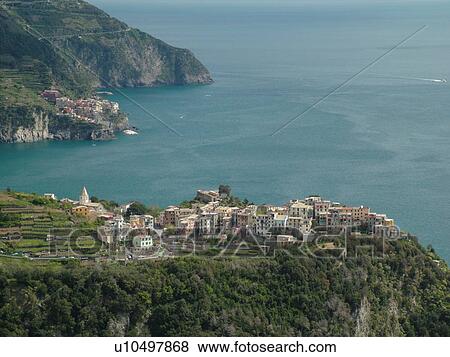 Liguria, Italy, Cinque Terre, Corniglia, Riviera di Levante, Ligurian Riviera, Europe, Scenic view of Corniglia, a Cinque Terre village, along the steep rocky coastline of the Ligurian Sea. View Large Photo Image Stock Photo - Liguria, Italy, Cinque Terre, Corniglia, Riviera di Levante, Ligurian Riviera, Europe, Scenic view of Corniglia, a Cinque Terre village, along the steep rocky coastline of the Ligurian Sea.. Fotosearch