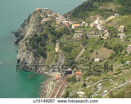Liguria, Italy, Cinque Terre, Corniglia, Riviera di Levante, Ligurian Riviera, Europe, Scenic view of Corniglia, a Cinque Terre village, along the steep rocky coastline of the Ligurian Sea. View Large Photo Image Stock Photo - Liguria, Italy, Cinque Terre, Corniglia, Riviera di Levante, Ligurian Riviera, Europe, Scenic view of Corniglia, a Cinque Terre village, along the steep rocky coastline of the Ligurian Sea.. Fotosearch