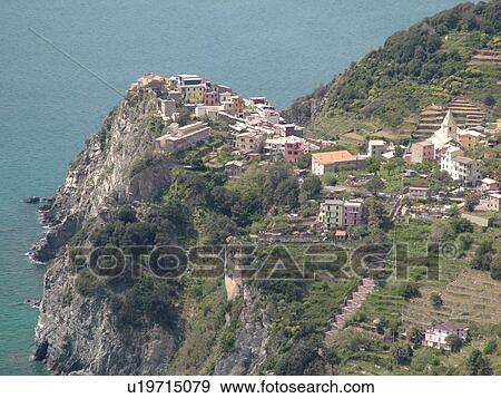 Liguria, Italy, Cinque Terre, Corniglia, Riviera di Levante, Ligurian Riviera, Europe, Scenic view of Corniglia, a Cinque Terre village, along the steep rocky coastline of the Ligurian Sea. View Large Photo Image Stock Photo - Liguria, Italy, Cinque Terre, Corniglia, Riviera di Levante, Ligurian Riviera, Europe, Scenic view of Corniglia, a Cinque Terre village, along the steep rocky coastline of the Ligurian Sea.. Fotosearch