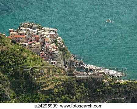 Liguria, Italy, Cinque Terre, Manarola, Riviera di Levante, Ligurian Riviera, Europe, Scenic view of Manarola, a Cinque Terre village, along the steep rocky coastline of the Ligurian Sea. View Large Photo Image Stock Photo - Liguria, Italy, Cinque Terre, Manarola, Riviera di Levante, Ligurian Riviera, Europe, Scenic view of Manarola, a Cinque Terre village, along the steep rocky coastline of the Ligurian Sea.. Fotosearch