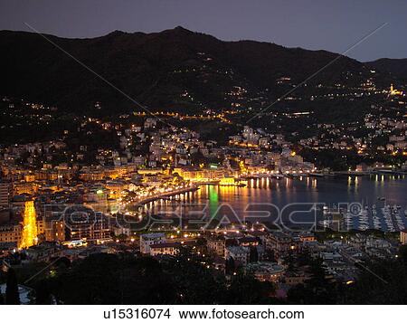 Liguria, Italy, Rapallo, Riviera di Levante, Ligurian Riviera, Europe, Scenic view of the resort town of Rapallo in the evening on the Gulf of Tigullio (Gulfo di Tigullio) along the Ligurian Sea on the Ligurian Riviera. View Large Photo Image Picture - Liguria, Italy, Rapallo, Riviera di Levante, Ligurian Riviera, Europe, Scenic view of the resort town of Rapallo in the evening on the Gulf of Tigullio (Gulfo di Tigullio) along the Ligurian Sea on the Ligurian Riviera.. Fotosearch
