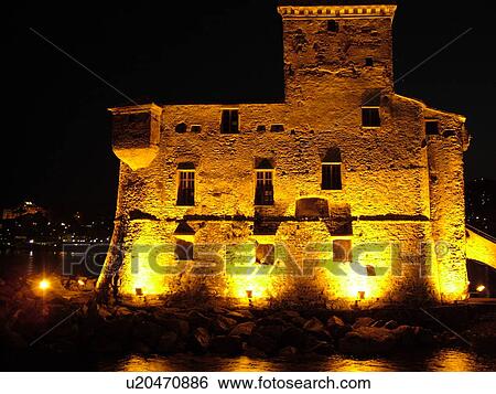 Liguria, Italy, Rapallo, Riviera di Levante, Ligurian Riviera, Europe, The Fortress illuminated at night on the Gulf of Tigullio (Gulfo di Tigullo) in the resort town of Rapallo along the Ligurian Sea on the Ligurian Riviera. View Large Photo Image Stock Photograph - Liguria, Italy, Rapallo, Riviera di Levante, Ligurian Riviera, Europe, The Fortress illuminated at night on the Gulf of Tigullio (Gulfo di Tigullo) in the resort town of Rapallo along the Ligurian Sea on the Ligurian Riviera.. Fotosearch