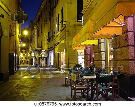 Liguria, Italy, Rapallo, Riviera di Levante, Ligurian Riviera, Europe, Outdoor cafT and shops along a narrow street in the resort town of Rapallo in the evening. View Large Photo Image Stock Photography - Liguria, Italy, Rapallo, Riviera di Levante, Ligurian Riviera, Europe, Outdoor cafT and shops along a narrow street in the resort town of Rapallo in the evening.. Fotosearch