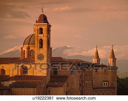 Stock Image -  Marche, Italy, Urbino, Europe, Scenic view of the Palazzo Ducale in the medieval hill town of Urbino at sunrise.. Fotosearch