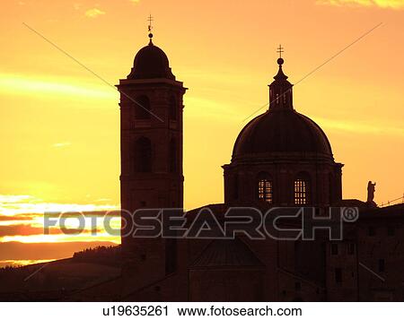 Stock Image -  Marche, Italy, Urbino, Europe, Silhouette of the Palazzo Ducale in the medieval hill town of Urbino at sunrise.. Fotosearch