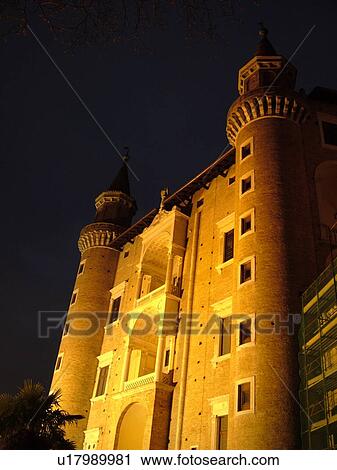 Stock Image -  Marche, Italy, Urbino, Europe, The Palazzo Ducale illuminated at night in the medieval hill town of Urbino.. Fotosearch