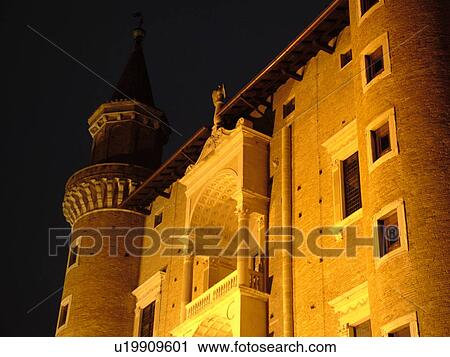 Stock Image -  Marche, Italy, Urbino, Europe, The Palazzo Ducale illuminated at night in the medieval hill town of Urbino.. Fotosearch
