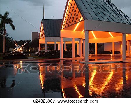 Stock Photo -  Naples, FL, Florida, The Philharmonic Center for the Arts, evening, reflection in pool of water. Fotosearch