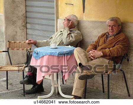 Narni, Italy, Umbria, Europe, Two Italian men sitting at an outdoor cafT in Piazza Garibaldi in the medieval town of Narni. View Large Photo Image Stock Image - Narni, Italy, Umbria, Europe, Two Italian men sitting at an outdoor cafT in Piazza Garibaldi in the medieval town of Narni.. Fotosearch