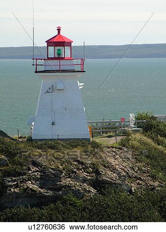 Stock Photograph -  New Brunswick, Canada, Bay of Fundy, Cape Enrage, Cape Enrage Lightstation ca. 1840, lighthouse, cliff. Fotosearch