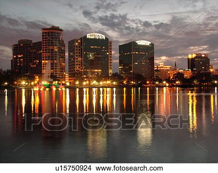 Picture -  Orlando, FL, Florida, Downtown skyline, Lake Eola, evening. Fotosearch