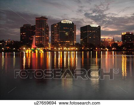 Picture -  Orlando, FL, Florida, Downtown skyline, Lake Eola, evening. Fotosearch