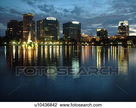 Stock Image -  Orlando, FL, Florida, Downtown skyline, Lake Eola, evening. Fotosearch