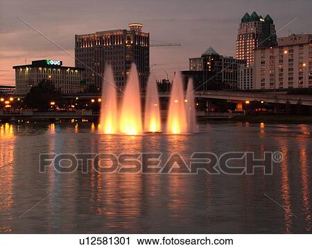 Orlando, FL, Florida, Downtown skyline, Lake Lucerne, illuminated fountain, evening View Large Photo Image Stock Image - Orlando, FL, Florida, Downtown skyline, Lake Lucerne, illuminated fountain, evening. Fotosearch