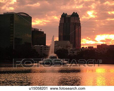 Stock Image -  Orlando, FL, Florida, Downtown skyline, Lake Eola, Lake Eola Park, sunset. Fotosearch