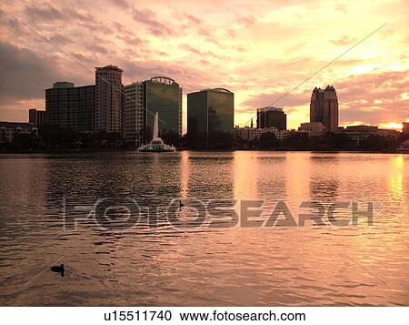 Stock Image -  Orlando, FL, Florida, Downtown skyline, Lake Eola, Lake Eola Park, sunset. Fotosearch