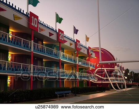 Orlando, FL, Florida, Lake Buena Vista, Disney's All-Star Sports Resort, evening, giant football field and helmets in the courtyard View Large Photo Image Stock Photo - Orlando, FL, Florida, Lake Buena Vista, Disney's All-Star Sports Resort, evening, giant football field and helmets in the courtyard. Fotosearch