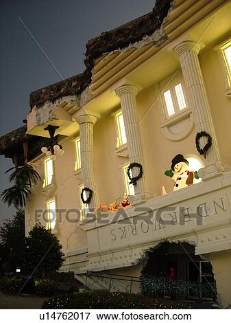 Stock Photo -  Orlando, FL, Florida, Wonder Works, upside-down buildings, evening. Fotosearch
