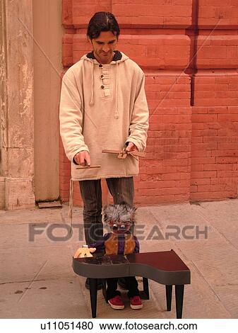 Stock Image -  Perugia, Umbria, Italy, Europe, Street artist along Corso Vannucci Street in the medieval town of Perugia.. Fotosearch