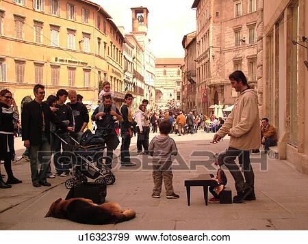 Perugia, Umbria, Italy, Europe, Street artist entertaining people along Corso Vannucci Street in the medieval town of Perugia. View Large Photo Image Stock Photo - Perugia, Umbria, Italy, Europe, Street artist entertaining people along Corso Vannucci Street in the medieval town of Perugia.. Fotosearch