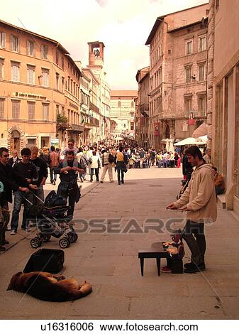 Perugia, Umbria, Italy, Europe, Street artist entertaining people along Corso Vannucci Street in the medieval town of Perugia. View Large Photo Image Stock Photograph - Perugia, Umbria, Italy, Europe, Street artist entertaining people along Corso Vannucci Street in the medieval town of Perugia.. Fotosearch