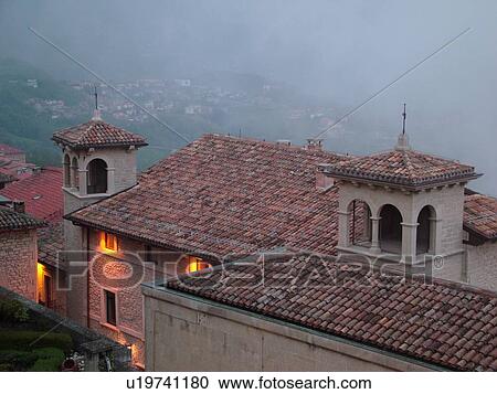Stock Image -  Republic of San Marino, San Marino, Europe, Italy, Republic of San Marino, Cassa di Risparmio in the hilly city-state of San Marino overlooking the Republic of San Marino in the evening.. Fotosearch