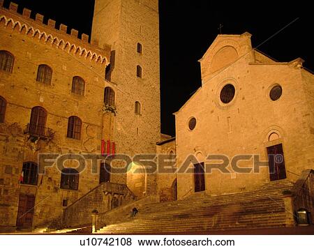 Stock Photo -  San Gimignano, Tuscany, Italy, Toscana, Europe, Duomo in the Piazza Duomo in the medieval town of San Gimignano in the evening.. Fotosearch