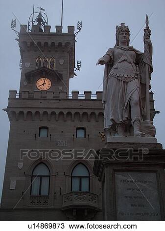 Stock Image -  San Marino, Italy, Europe, Republic of San Marino, Statue della Liberta outside the Palazzo Publico in the hilly city-state of San Marino in the evening.. Fotosearch