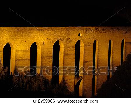 Stock Photograph -  Spoleto, Umbria, Italy, Europe, Ponte delle Torri (Bridge of the Towers) illuminated at night in the medieval city of Spoleto.. Fotosearch