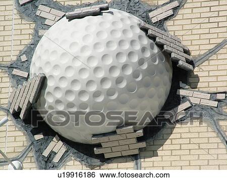 Stock Photograph -  St. Augustine, FL, Florida, Golf Hall of Fame, World Golf Village, Giant golf ball in the side of a building, St. Johns County Cradle of Golf. Fotosearch
