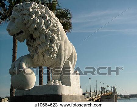Stock Image -  St. Augustine, FL, Florida, The Old City, Lion Statue guards The Bridge of Lions, Matanzas Bay. Fotosearch