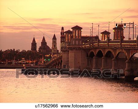 Stock Photograph -  St. Augustine, FL, Florida, The Old City, The Bridge of Lions spans Matanzas Bay at sunset. Fotosearch