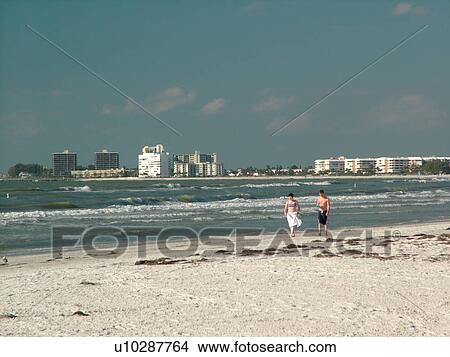 Picture -  St. Petersburg, FL, Florida, Tampa Bay, St. Pete Beach, Gulf Coast Beaches, young couple walking on the beach. Fotosearch