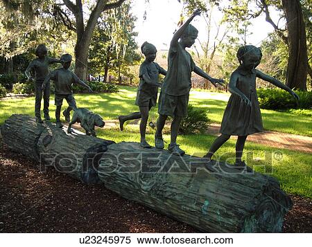 Stock Photography -  Tallahassee, FL, Florida, Children at play on a log sculpture on the grounds of the Governor's Mansion. Fotosearch