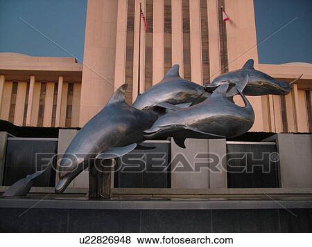 Stock Photo -  Tallahassee, FL, Florida, New State Capitol, State House a 22-story tower, Dolphin statue and fountain on the capital grounds. Fotosearch