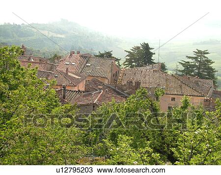 Stock Image -  Tuscany, Italy, Montepulciano, Toscana, Europe, Scenic view of the rooftops of buildings in the medieval hilltop village of Montepulciano.. Fotosearch