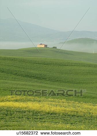 Stock Image -  Tuscany, Italy, Pienza, Toscana, Europe, Scenic view of a Tuscan home and the countryside of Tuscany in the fog in Pienza.. Fotosearch