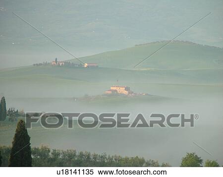 Stock Photography -  Tuscany, Italy, Pienza, Toscana, Europe, Scenic view of a Tuscan homes and the countryside of Tuscany in the fog in Pienza.. Fotosearch