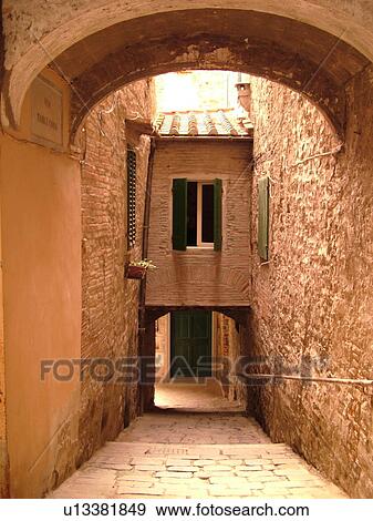 Stock Photo -  Tuscany, Italy, Poppi, Toscana, Europe, Archway in narrow alley in the town of Poppi in the Casentino hill region.. Fotosearch