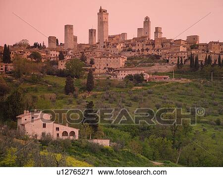 Stock Image -  Tuscany, Italy, San Gimignano, Toscana, Europe, Scenic view of the medieval town of San Gimignano at sunrise in the Chianti Region.. Fotosearch