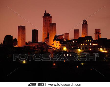 Stock Image -  Tuscany, Italy, San Gimignano, Toscana, Europe, Scenic view of the medieval town of San Gimignano in the evening in the Chianti Region.. Fotosearch