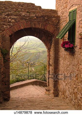 Stock Photo -  Tuscany, Italy, Volterra, Toscana, Europe, Archway and windows on a building in the medieval town of Volterra.. Fotosearch