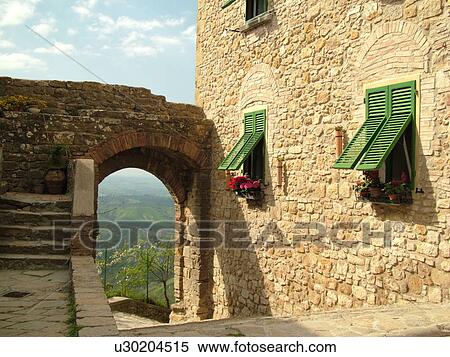 Stock Photography -  Tuscany, Italy, Volterra, Toscana, Europe, Archway and windows on a building in the medieval town of Volterra.. Fotosearch