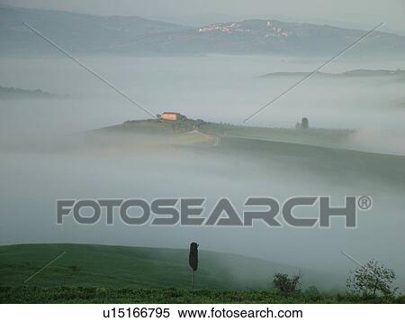Stock Photography -  Tuscany, Pienza, Italy, Toscana, Europe, Scenic view of a Tuscan home and the countryside of Tuscany in the fog in Pienza.. Fotosearch