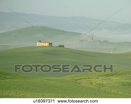 Stock Image -  Tuscany, Pienza, Toscana, Italy, Europe, Scenic view of a Tuscan home and the countryside of Tuscany in the fog in Pienza.. Fotosearch