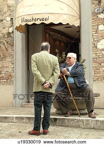 Umbria, Italy, Narni, Europe, Two Italian men talking together in Piazza Garibaldi in the medieval town of Narni. View Large Photo Image Stock Photo - Umbria, Italy, Narni, Europe, Two Italian men talking together in Piazza Garibaldi in the medieval town of Narni.. Fotosearch